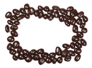 Chocolate coated raisins frame and border isolated on white background