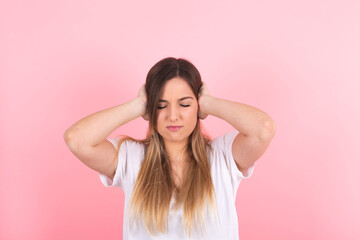 young woman covering her ears. Annoying noise