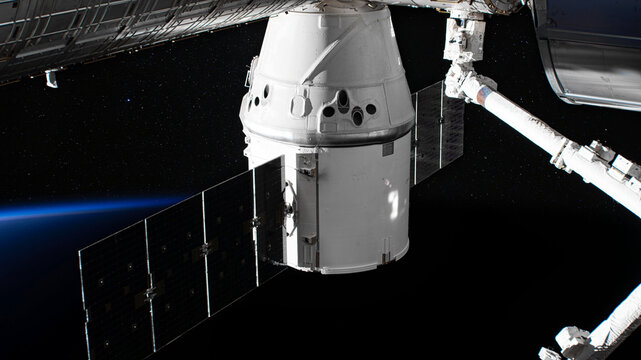 The SpaceX Crew Dragon spacecraft is docked to the International Space Station. Elements of this image furnished by NASA