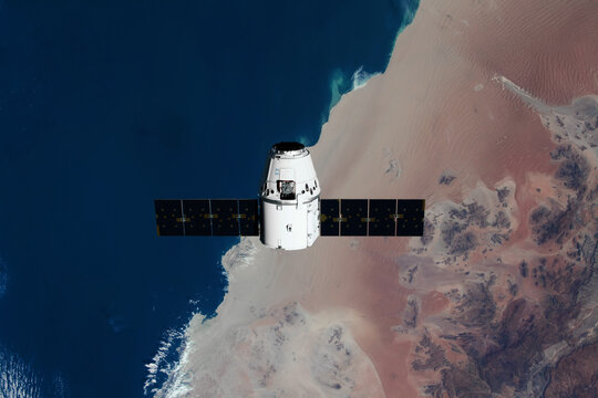 The SpaceX Dragon resupply ship is pictured approaching the International Space Station. Elements of this image furnished by NASA
