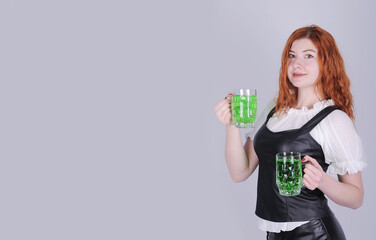  St. Patrick's Day.Woman with beer on gray background