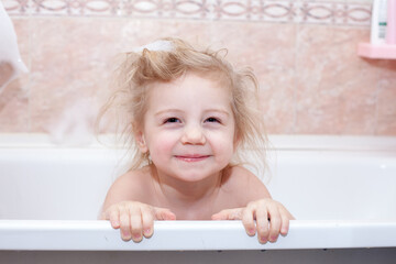 Baby bathing and smiling in  bubble bath