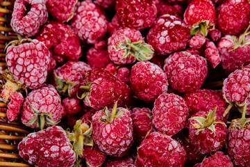 Top view of heap of raspberries in wooden basket