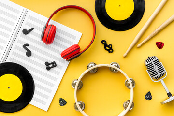 Music flat lay - instruments with vinyl records, overhead view