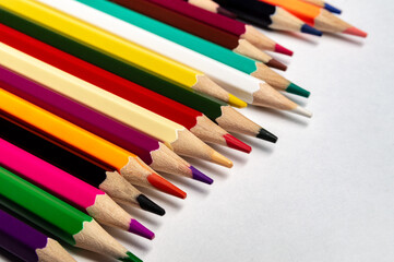 colored pencils on a white sheet of paper