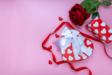 Gift or present box and red rose on pink background. for banner. The concept of Valentine Day. top view, copy space