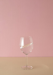 Be different. One  glass, on a pastel background. creative concept. Minimal.