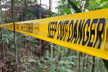 Selective focus image of keep out danger warning tape in the park