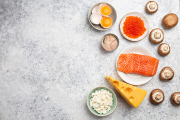 Selection of natural sources of vitamin D: fresh salmon; caviar; cheese; mushrooms; tuna; eggs on...