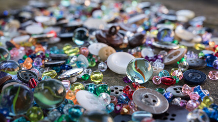 A group of randomly scattered beads, buttons and marbles