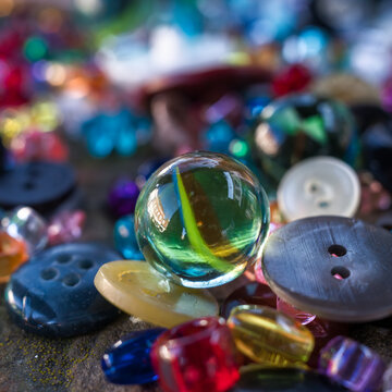 A Group Of Randomly Scattered Beads, Buttons And Marbles