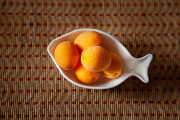 large horizontal photo. seasonal fruits on a figured plate in the form of a fish. big ripe...