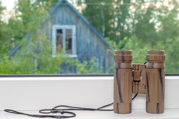 Obraz premium binoculars green window sill
