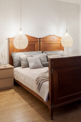 Double wooden bed in simple bedroom