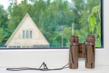 the binoculars on the window sill