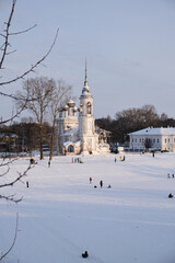 White stone church on the winter embankment.