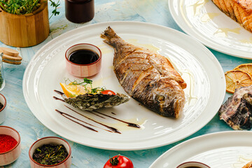 Gourmet grilled dorada fish on the served table on blue background