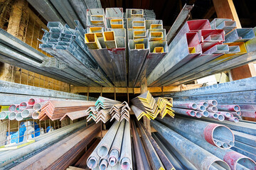 Close-up wide-angle view of aluminum bars and metal steel pipes for sale at a hardware store in the Philippines, Asia