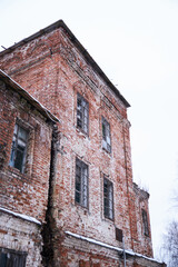 Fototapeta na wymiar Old and ruined brick church in cold winter