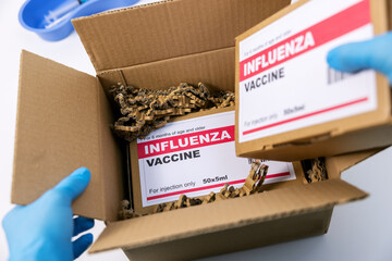 medical products distribution and shipping. opened box with flu vaccine packages