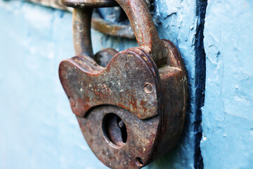 old rusty padlock on blue wooden door
