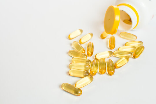 Cod liver oil capsules isolated on white backgrund. Omega 3 pils for healthy heart, cardiovascular system and brain.
