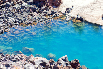 Blue lake in the highlands of the Elbrus region. Small beautiful lake at the bottom of the gorge