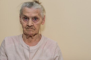 Elderly woman portrait isolated on light background