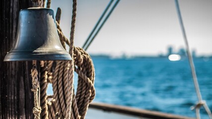 Bell and hanging ropes on cruising yacht
