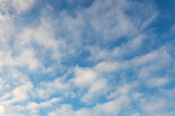 High white cirrus clouds with cirro-stratus in a light blue sky, sometimes called chair tails,...