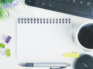 flat lay office workspace desk with coffee,blank notebook, electronic devices and computer....