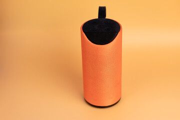  orange speaker for music on a yellow background