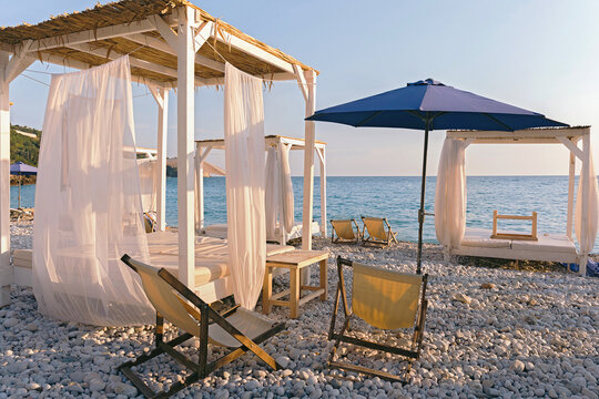 Beautiful canopies or baldachine at sea beach at the sunset. Vacation and relaxation concept.