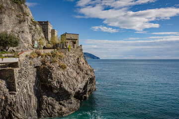 Fototapeta na wymiar Monterosso al Mare, a coastal village and resort in Cinque Terre, Italy. Way to the small touristic town: stone stairs on the rock wall, tunnel through the mountain and defensive naval bunker