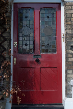 A red front door with a stained glass pattern.