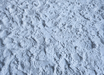 Human traces in the snow.  Footprints on white snow , full background of boots