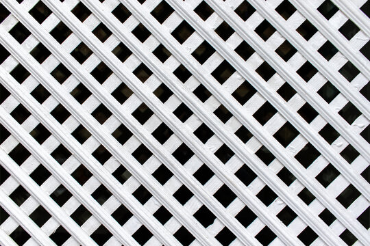 White wooden window lattice. Wooden blinds close-up.