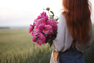 Beautiful girl with a bouquet peony © Sergii Mostovyi