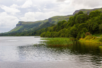 A view across Glencar Lough which lies in Counties Sligo and Leitrim in Ireland. Taken on a cloudy day with the Dartry Mountains in the background