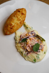 Kiev cutlet with mashed potatoes, vegetables and corn. National dish on a white plate close-up.