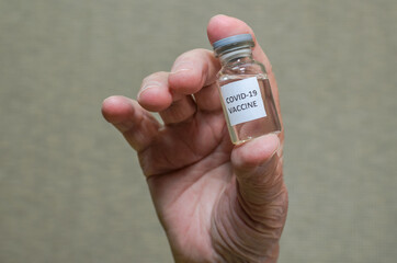 Covid-19 vaccine in the hand of an elderly woman