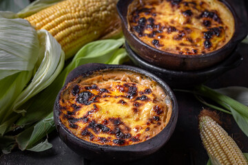 Latin American Corn pie. Chilean Pastel de Choclo in clay bowl
