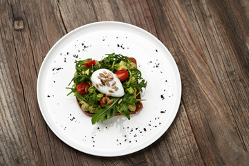 Poached egg toast with guacamole avocado sauce.