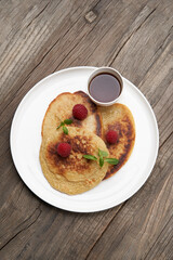 Healthy oat pancakes with raspberry berries and honey syrup