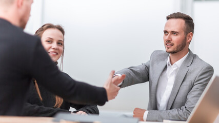 business people greeting each other with a handshake.