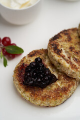 Cottage cheese pancakes with berry jam and sour cream