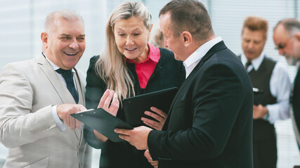 group of business people discussing financial documents.