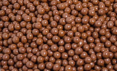 Brown dragee, chocolate covered nuts, background
