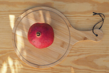 Ripe pomegranate fruit on wooden background. Top view.