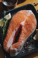 Raw salmon steak with lemon and thyme